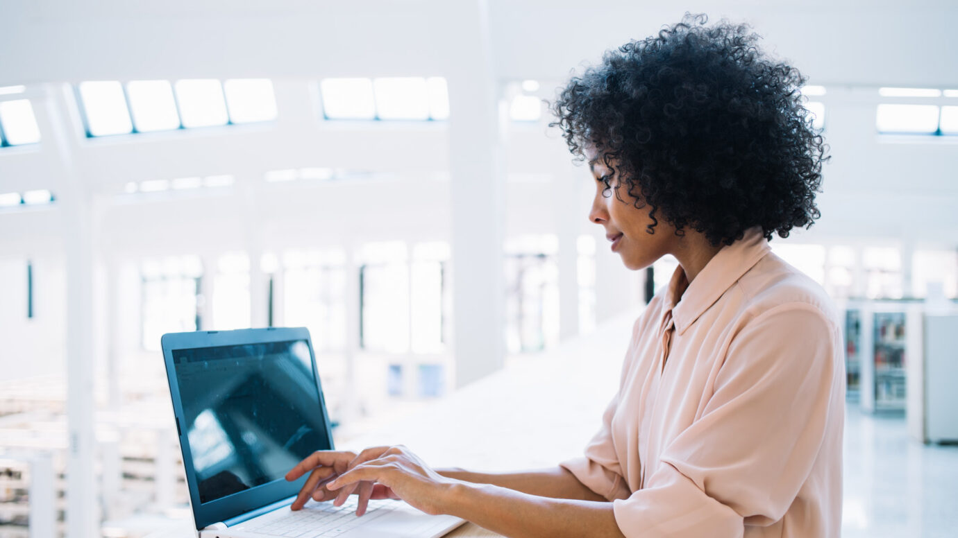 Woman working in clinical data management services at her laptop