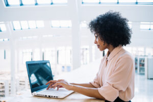 Woman working in clinical data management services at her laptop