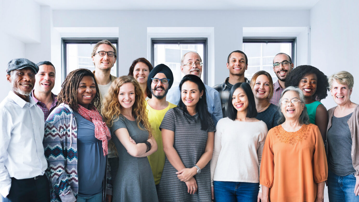 Smiling group of diverse clinical trial volunteers gathered by patient recruitment